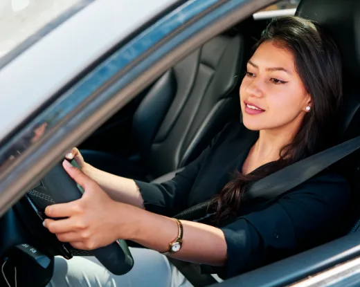 A young adult driving.